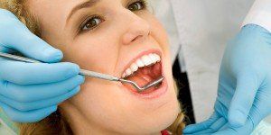 Having gums examined for gum disease